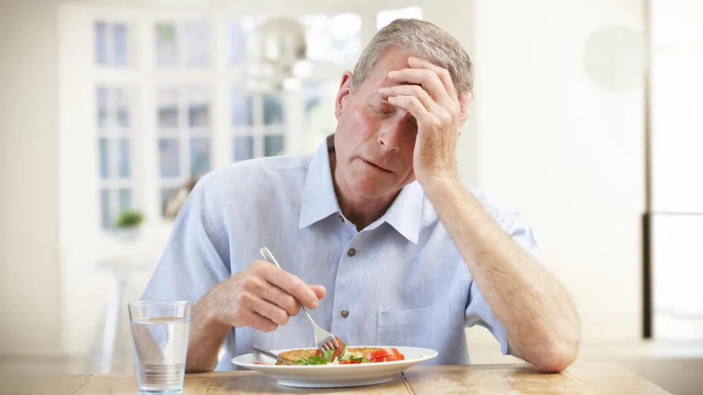 sick old man trying to eat.webp.webp