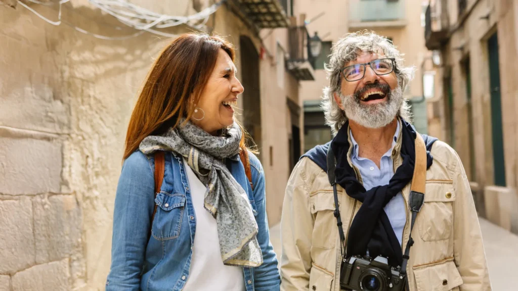 Scientists say go back and forth may just gradual growing old and spice up your well being happy senior couple sightseeing in barcelona.webp.webp