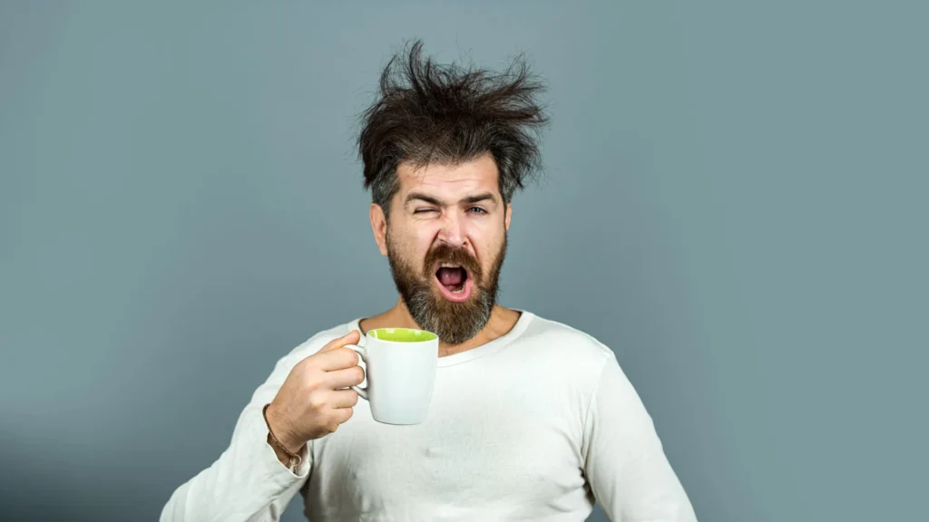 Caffeine reversed reminiscence issues brought about by way of sleep deprivation tired man with messy hair drinking morning coffee.webp.webp