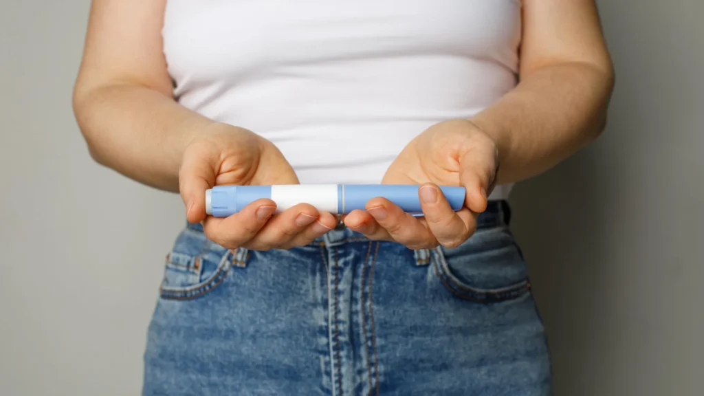 woman holding semaglutide ozempic weight loss diabetes pen.webp.webp